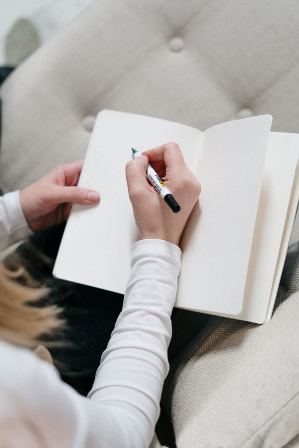 A woman writing on her journal