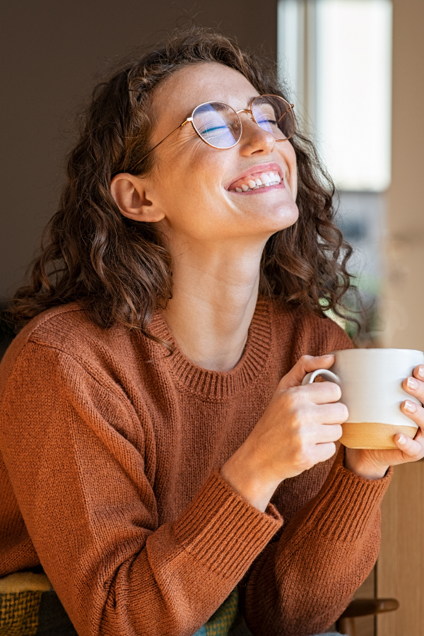 A happy woman holding a coffee cup