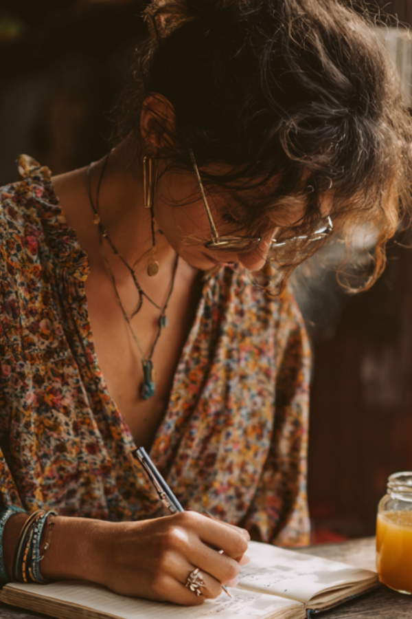 A woman writing on her journal