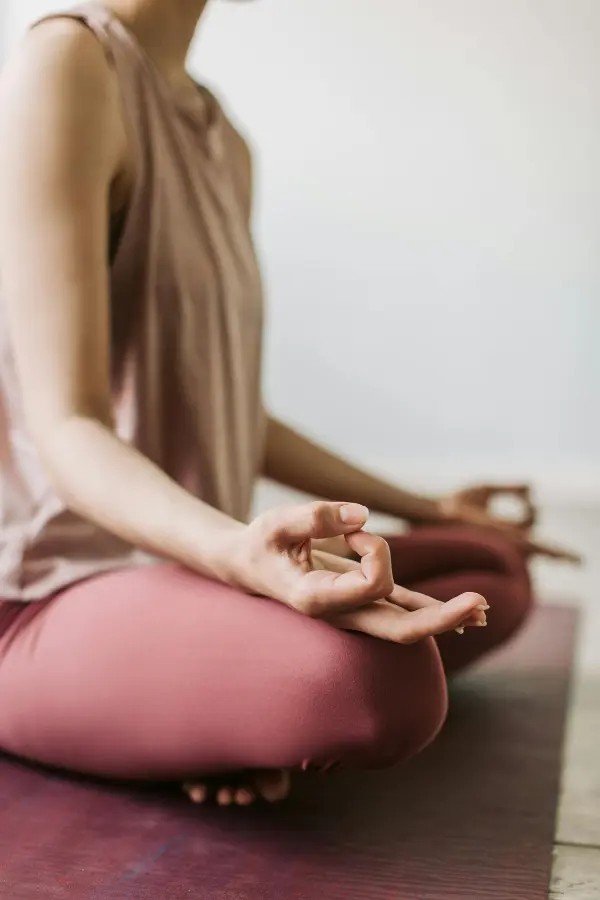 A close-up photo of a woman's hand while posing for meditation