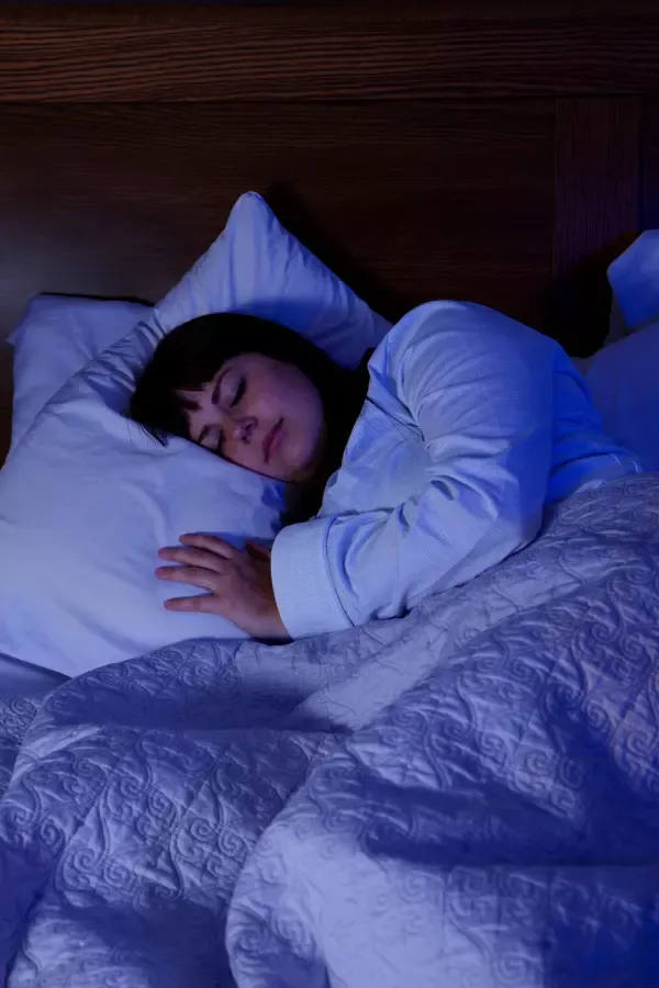 A woman sleeping on her bed