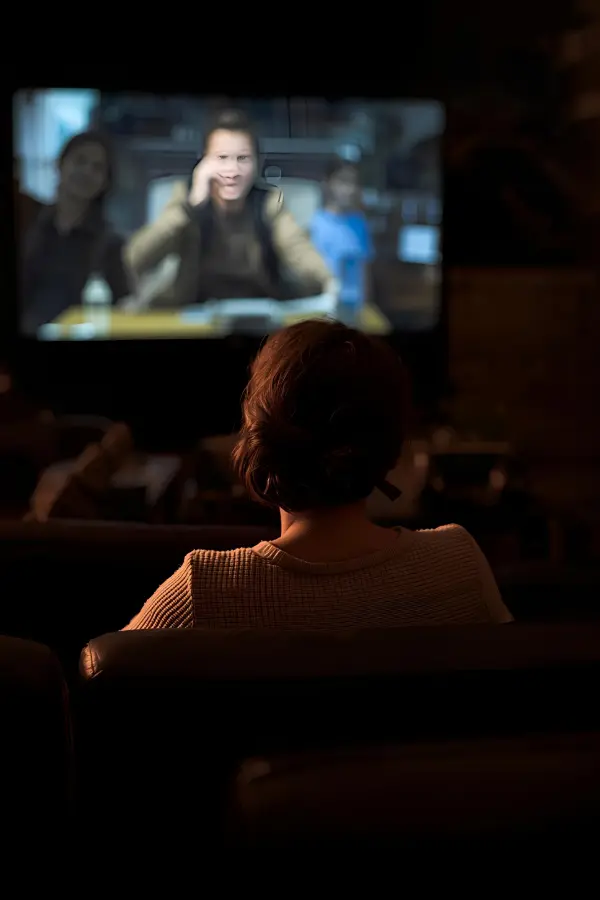 A woman watching a movie allone
