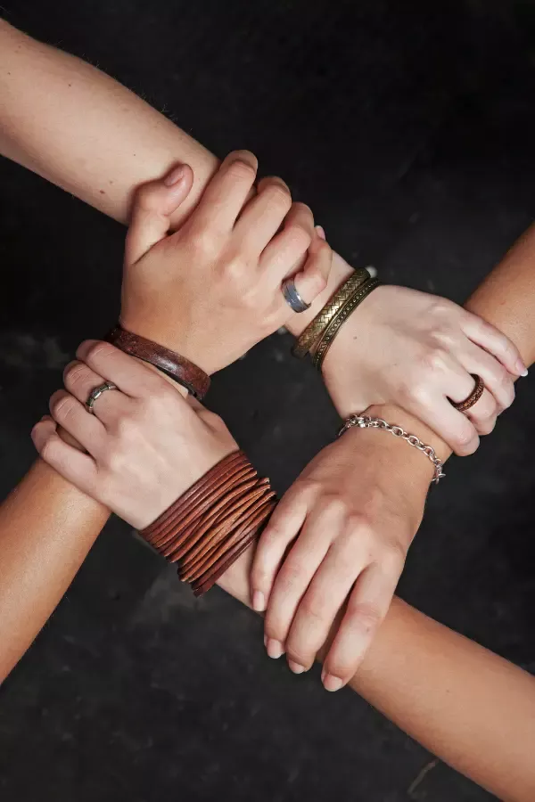 A group of friends holding each others' hands
