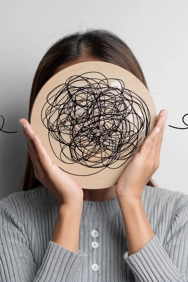 A woman holding a representation of mixed thoughts