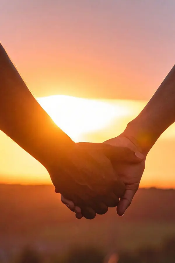 Two people holding hands