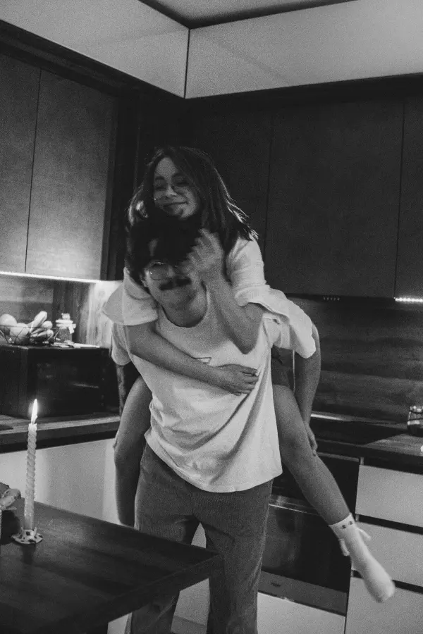 A woman piggy back riding a man